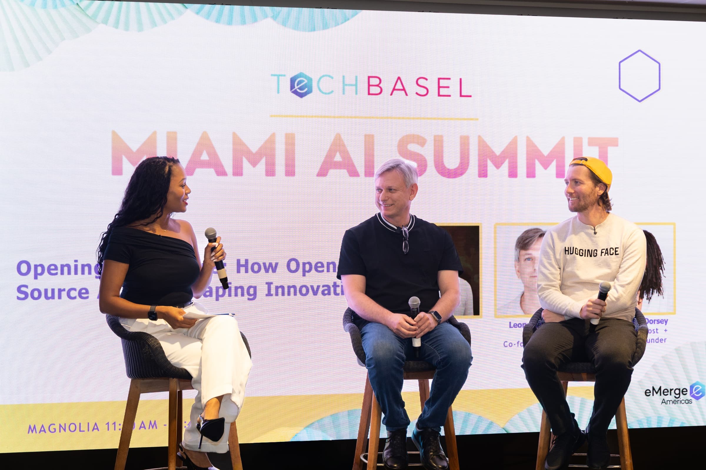 Three speakers in conversation on stage at Miami AI Summit